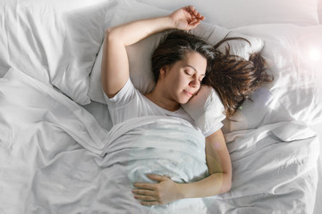woman sleep in bed sunshine thought the window