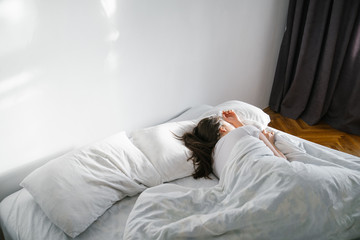 woman sleep in bed sunshine thought the window