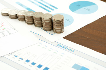 Business chart with paper clips, coins
