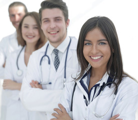 female doctor with group of happy successful colleagues