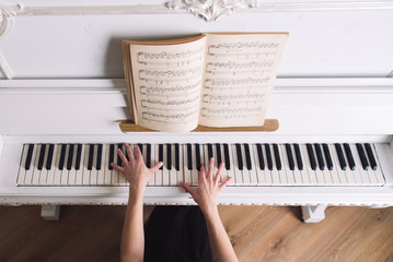 young blond woman play no white piano © phpetrunina14