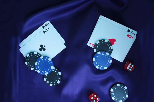 Poker game concept with chips, cards on purple background. Top view, copy space