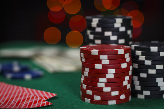 Poker chips and cards on the green table