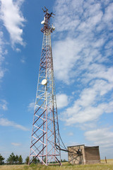Obraz premium TV and radio translation tower in the steppe against a blue sky