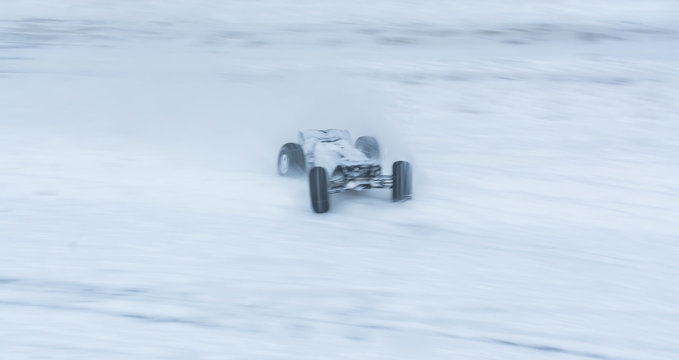 Fototapeta Toy sports cars on winter rally. Motion blur.