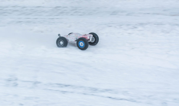 Fototapeta Toy sports cars on winter rally. Motion blur