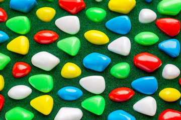 Green Texture with plastic colorful rocks