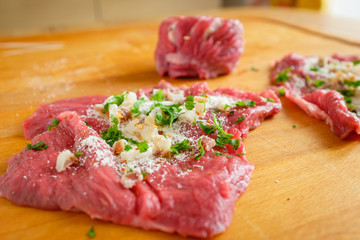 Making stuffed meat roll called braciola typical of Apulia region, Italy