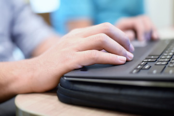 Close-up man hand use laptop.