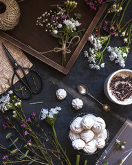 Composition with flowers, coffee and marshmallow cookies. The conception of wedding or birthday