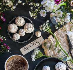 Composition with flowers, coffee and marshmallow cookies. The conception of wedding or birthday