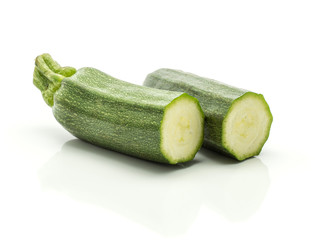 Two green zucchini halves isolated on white background long raw courgette.