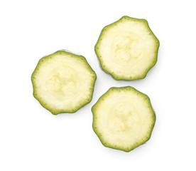 Three green zucchini round slices top view isolated on white background raw courgette pieces.