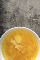 Bowl of chicken soup on a dark background. Delicious chicken broth 2