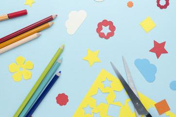 multi-colored pencils, scissors and bright paper decorations