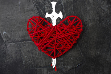 Red heart pierced with a sword. The theme of broken love 1