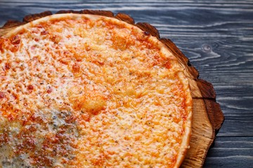 Pizza crust close up. Appetizing quattro formaggi cheese pizza on wood