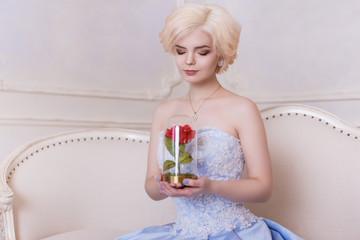 Glamorous girl, blond woman. Cinderella, the princess in the castle. A rich, white queen in a blue...