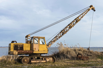 Old rusty excavator for extracting fish