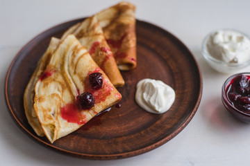 pancakes with sour cream and cherry jam