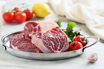 Beef cut with fresh vegetables. Raw meat ready to cook with seasonal vegetables. Osso bucco ingredients. Selective focus