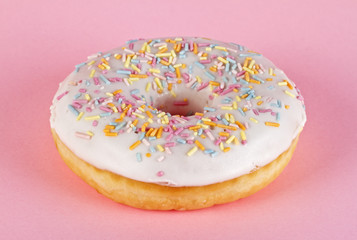 Delicious donut on pink background, closeup