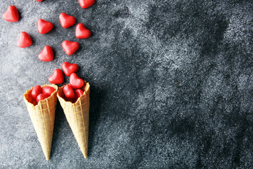 Valentine day candy with red hearts and cones