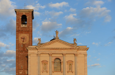 church of santa maria assunta with bell tower in the autumn evening sun in Gallarate, Varese, Italy