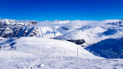Winter holiday in the Alps mountains under blue sky