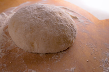 Dough on a wooden Board with flour