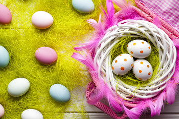 Easter background - White and colored eggs on wooden background