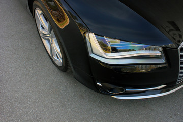 Obraz na płótnie Canvas Part of the car on the background of asphalt