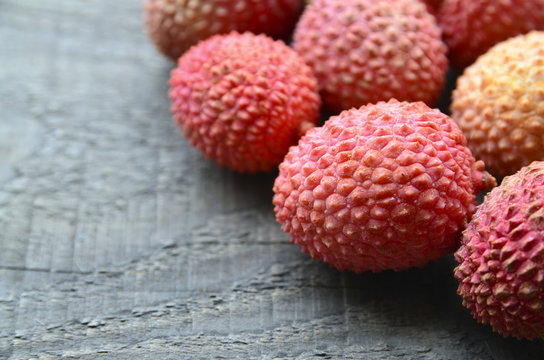 Fresh organic lychee fruits on a rustic wooden background.Lychees.Raw diet or vegan food concept.Selective focus.