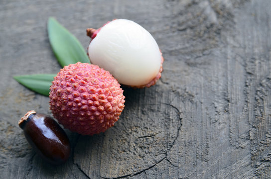 Fresh organic lychee fruits on a rustic wooden background.Lychees.Raw diet or vegan food concept.Selective focus.