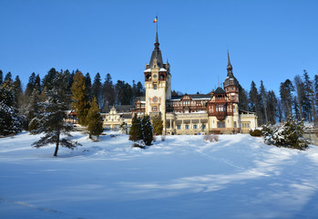 Fototapeta na wymiar Peles Castle in winter time, located in the Carpathian Mountains, Sinaia, Romania