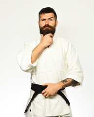 Man with beard in white kimono on white background.