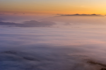 A fascinating landscape. Sunrise over the clouds.