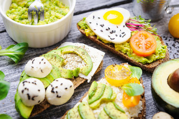bruschetta with avocado microgrin, quail eggs and Adyghe cheese and mozzarella