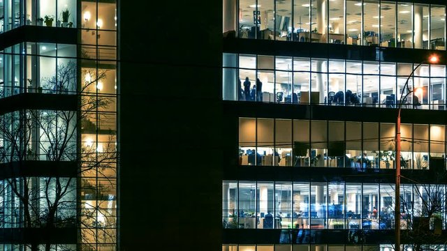 Office work at night in modern skyscraper with a lot of people. Time lapse 