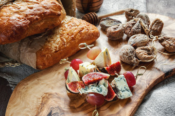 Italian Focaccia bread with cheese and a cheese plate with figs and Gorgonzola, brie, DorBlu and grapes.