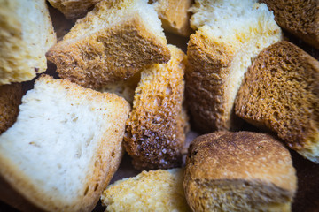 Fried croutons of white bread. A close-up photograph.