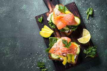 Open sandwich with salmon spinach and avocado.