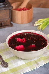 Traditional polish clear red borscht with dumplings.