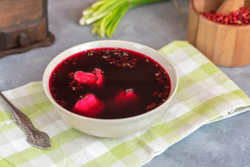 Traditional polish clear red borscht with dumplings.