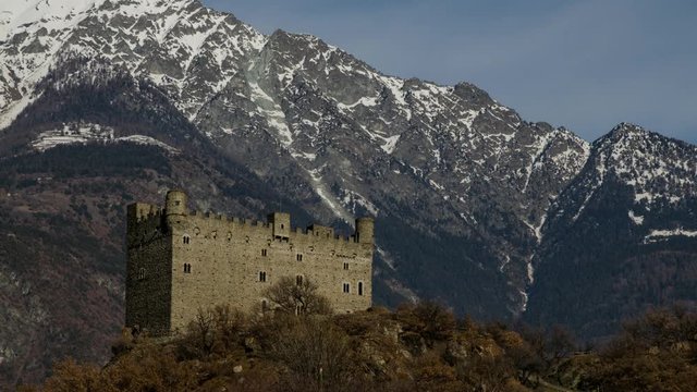 Ussel fraction of Chatillon, Valle d'Aosta, Italy 11 February 2018. Three-quarters rise to the left of the medieval castle of Ussel. Timelaps of 20 minutes in 10 seconds. The clouds flow over mountain