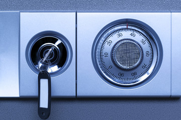 Closeup of a secure lock in a vault in blue tones.