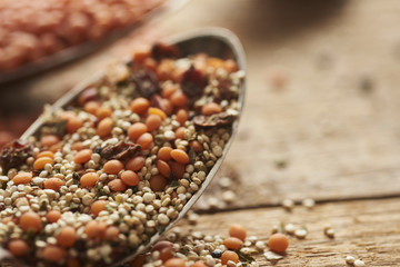 vintage spoons with different ingredients lieing on wooden old table