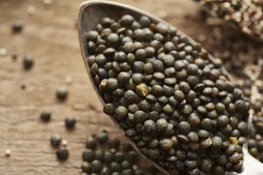 close up of puy lentils on old silver spoon