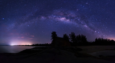 Stitched Panorama starry night sky with milky way.  image contain soft focus, blur and noise due to long expose and high iso.