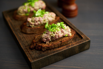 bruschetta, on slices of toasted baguette garnished with basil